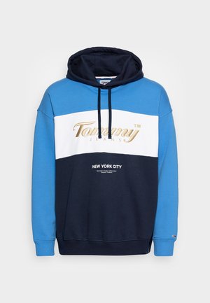 Hoodie in blauw, wit en marineblauw; met gouden logo "Tommy Jeans" en tekst "NEW YORK CITY" op de voorkant; van een katoenmix.