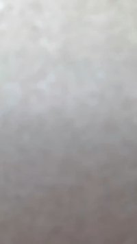 Soft gray ceramic bowl with a smooth texture and rounded shape, featuring a subtle speckled pattern. Suitable for serving or decor.