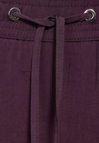 Fascia in vita con cordino viola e occhielli in metallo, realizzata in un tessuto leggero e liscio con dettagli di cucitura visibili.