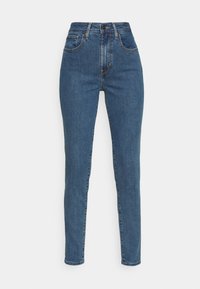 Jeans azules de cintura alta hechos de denim, que presentan una textura suave, cinco bolsillos y sutiles detalles de costura a lo largo de las costuras.