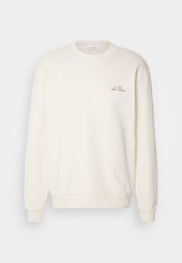 Sweat-shirt crème à manches longues avec poignets côtelés, col rond et broderie "Les Deux" sur la poitrine gauche.