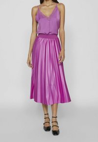 Purple satin pleated midi skirt paired with a matching camisole featuring lace trim. Smooth texture, elastic waistband, and layered design.