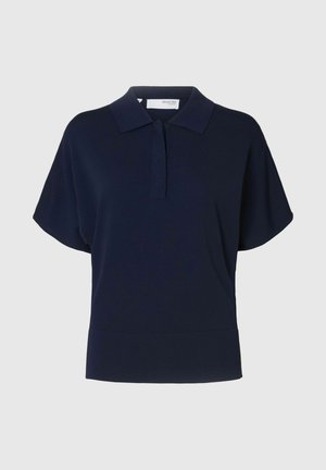 Polo bleu marine avec une texture douce, des manches courtes et un col classique, présentant un plastron à deux boutons et une coupe décontractée.