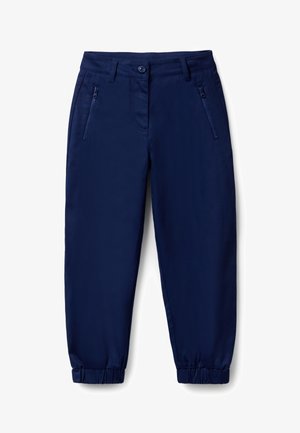 Pantalon bleu marine à coupe ajustée, avec fermeture à bouton, poches zippées et poignets élastiqués pour une silhouette fuselée.