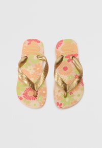 Flip-flops with a floral pattern in pink, orange, and green on the footbed; gold textured straps; lightweight design.
