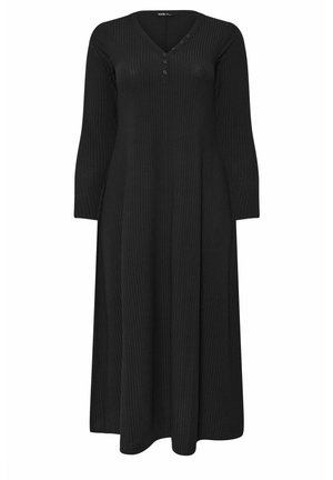 Vestido negro de manga larga con textura acanalada y escote en V, con cierre de botón en el pecho y falda acampanada en forma de A. Textura suave.
