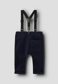 Pantalones de algodón azul marino con puños doblados, tirantes ajustables y un único bolsillo trasero. Acentos de cuero ajustables en los tirantes.