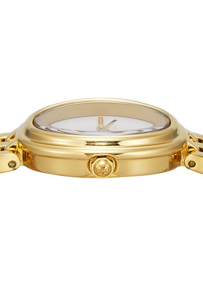 Gold wristwatch side view showing smooth rounded case, crown with logo, and partially visible white dial with gold hands.