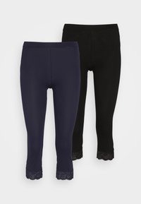 Leggings en bleu marine et noir, avec un ourlet en dentelle festonnée à la cheville. Fabriqués en matériau doux et extensible pour le confort.