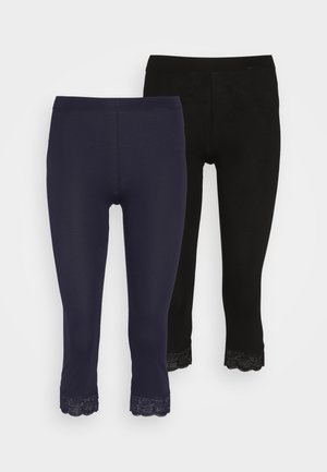Leggings in navy blue and black, featuring a scalloped lace trim at the ankle. Made of soft, stretchy material for comfort.