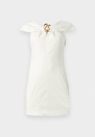 White sleeveless dress with a bow-like neckline and a decorative gold hardware detail at the center. Linen texture; fitted silhouette.