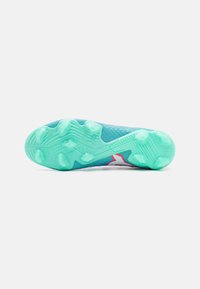 Sport shoe with a textured aqua outsole, featuring a red accent and a light blue upper mesh. Distinctive stud pattern on the sole.
