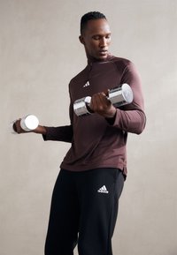 adidas Sportswear ESSENTIALS - Teplákové kalhoty - black