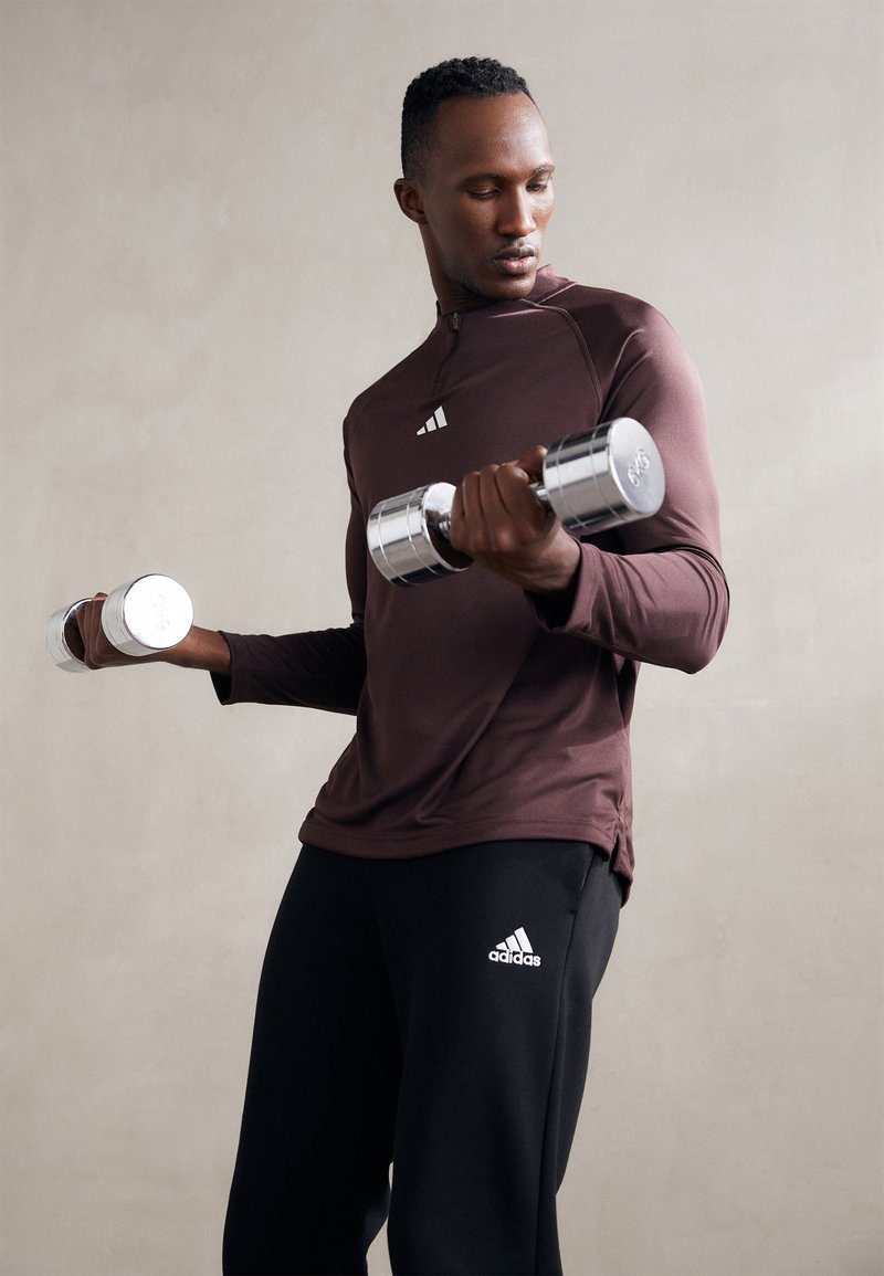 adidas Sportswear ESSENTIALS - Teplákové kalhoty - black