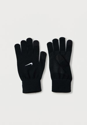 Guantes negros con un diseño de punto, puños acanalados y un logo de swoosh blanco de Nike. Superficie texturizada en las yemas de los dedos para mejorar la funcionalidad.