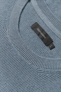 Light blue knitted sweater with a textured body, ribbed neckline, and a black label reading "Martinique" with size "L."