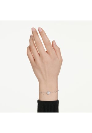 Bracelet en argent avec un cristal central en forme de cercle et de petites perles le long de la chaîne ; porté sur une main avec des ongles rose neutre.