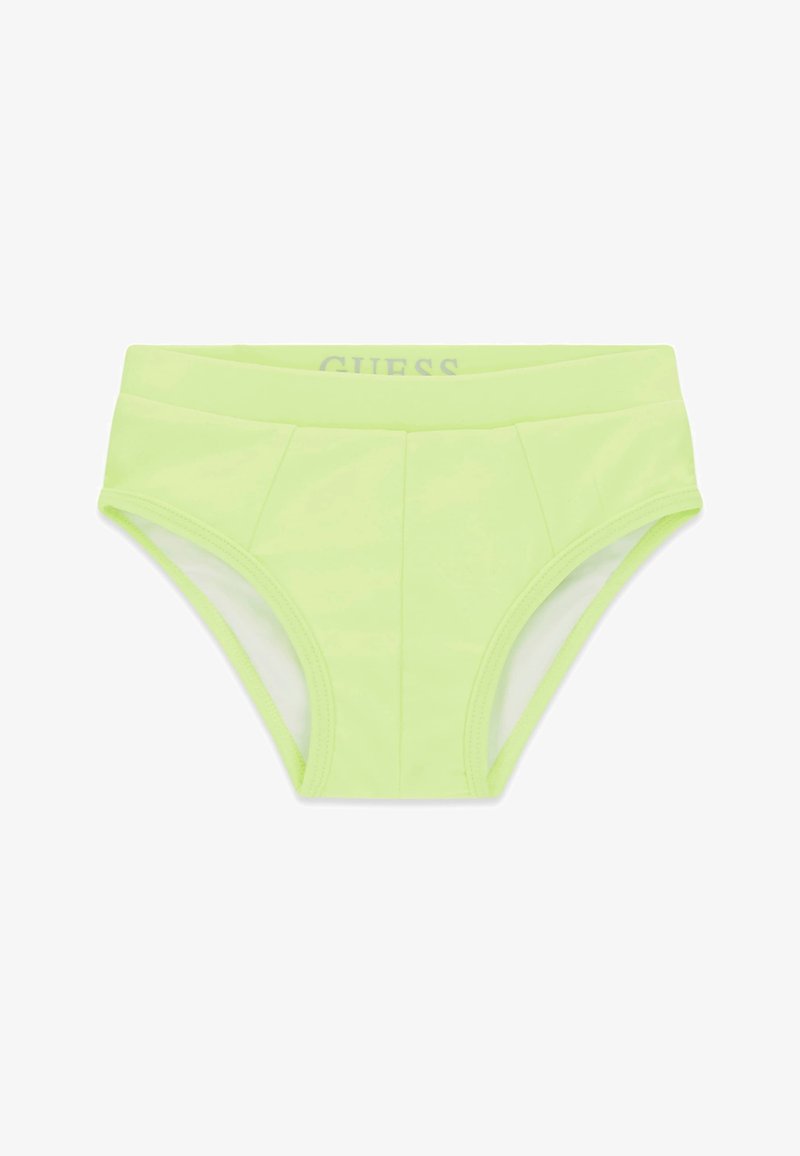 Slip de bain homme vert clair avec une large ceinture et une couture visible à l'avant, marqué GUESS à l'intérieur de la ceinture.