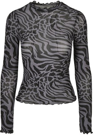 Långärmad, genomskinlig topp i svart och grå zebramönster, med en volangkrage och vågig nederkant som framhäver ett strukturerat mönster.