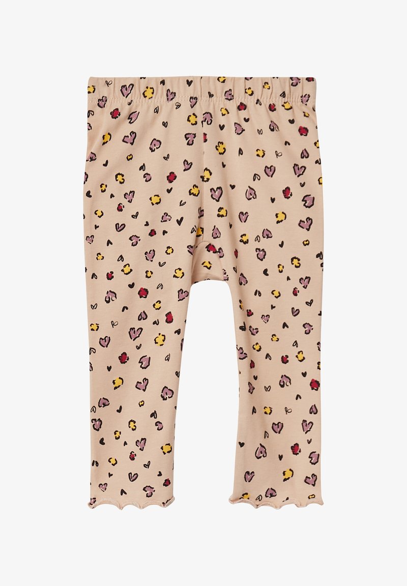 Lichtbeige leggings met een golvende zoom, met een speels patroon van harten en stippen in tinten van roze, geel en zwart. Zacht materiaal.