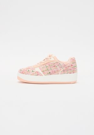 Pink tweed sneakers with a textured upper, white sole, and pink accents. Features lace-up design and thick platform for added height.