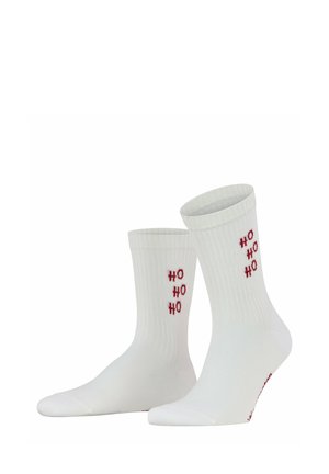 Calzini bianchi crew con testo rosso "HO HO HO" lavorato verticalmente sul lato di ogni calzino.