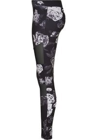 Blommiga leggings med mönster i svart, vitt och grått. Tillverkade av elastiskt tyg med nätinslag på sidorna för andningsförmåga och stil.