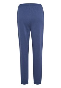 Marineblauwe joggingsbroek van zachte stof, met een elastische tailleband en manchetten, een gladde textuur en een slanke pasvorm.