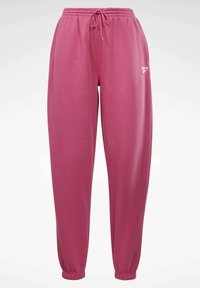 Różowe dresy z bawełny z elastycznym pasem, sznurkiem i elastycznymi mankietami, z małym białym logo po lewej stronie.