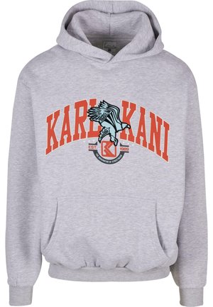 Lichtgrijze hoodie met oranje "KARL KANI" tekst en blauwe arend grafiek boven de voorzak, met "EST. 1989" en streetwear-logo.