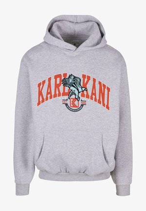Lichtgrijze hoodie met oranje "KARL KANI" tekst en blauwe arend grafiek boven de voorzak, met "EST. 1989" en streetwear-logo.