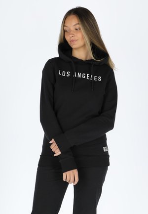 Black hoodie with "LOS ANGELES" text on the front. Features a drawstring hood, ribbed cuffs, and a relaxed fit. Soft fabric texture.