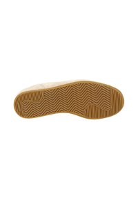 Suola della scarpa in materiale gommoso, con un motivo a zigzag per la trazione, di un beige chiaro con scanalature testurizzate e una forma arrotondata.