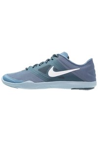 Blue athletic shoe with mesh upper, a white Nike logo, and a textured sole. Features a low profile and lace-up design.