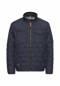 Veste matelassée marine avec un col montant, une fermeture éclair, deux poches poitrine, des boutons latéraux et un détail d'étiquette sur le côté gauche.