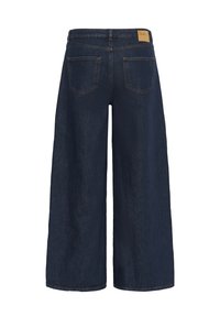 Wide-leg dark blue denim jeans shown from the back with two back pockets and a tan brand label on the waistband.