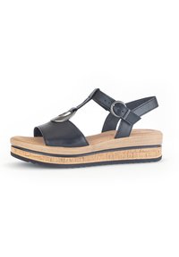 Black leather wedge sandal with an adjustable ankle strap, open toe, metallic accent, and a textured natural wood platform.