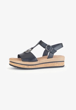 Black leather wedge sandal with an adjustable ankle strap, open toe, metallic accent, and a textured natural wood platform.