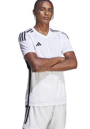 Witte mesh voetbalshirt met korte mouwen, zwarte strepen en drie diagonale accenten; lichtgewicht stof, V-hals ontwerp, gecombineerd met witte shorts.
