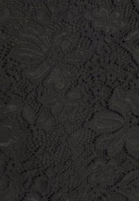 Tissu en dentelle noire présentant des motifs floraux complexes et une texture lisse. Le design comprend plusieurs tissages et des détails en ajouré.