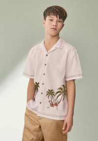 Light pink short-sleeve shirt featuring palm tree and floral embroidery, brown buttons, and decorative stitches along the collar and sleeves.