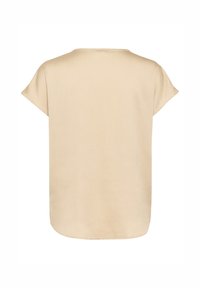 Beige kortärmad topp med lös passform. Slät textur och rund nederkant. Enkel design utan synliga dekorationer.