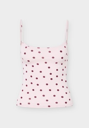 Světle růžová košilka s tenkými ramínky a tmavě fialovými puntíky rovnoměrně rozptýlenými po celé látce.