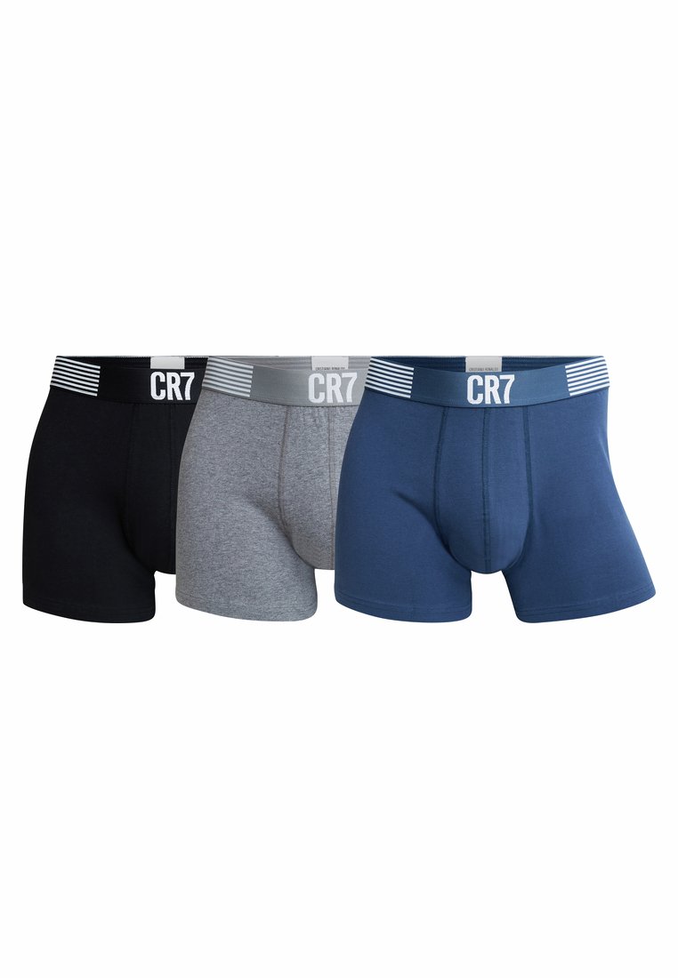 Three pairs of boxer trunks in black, gray, and navy. Each has a contrasting waistband with the text "CR7" and subtle stripe accents.