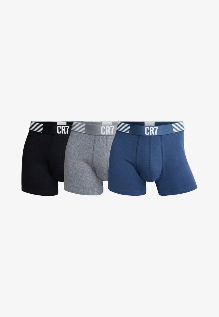 Three pairs of boxer trunks in black, gray, and navy. Each has a contrasting waistband with the text "CR7" and subtle stripe accents.