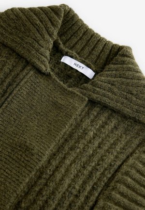 Olive green knit sweater with a ribbed collar and textured fabric. Features a label with "NEXT" inside the collar.