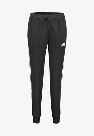 Pantaloni sportivi neri con vita regolabile, vestibilità affusolata e strisce bianche sui lati. Realizzati in un materiale morbido, con il logo Adidas sull'anca.