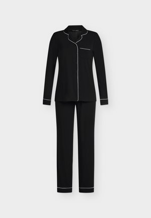 Haut de pyjama noir à manches longues avec boutons et pantalon assorti, avec passepoil blanc sur le col, les poignets, la poche et les ourlets du pantalon sur fond uni.