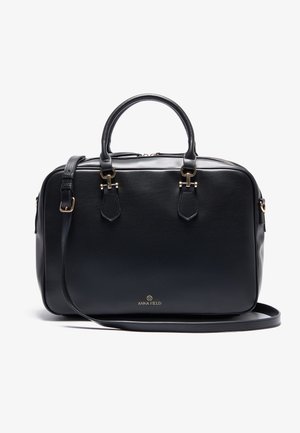 Sac à main rectangulaire en cuir noir avec deux poignées, bandoulière réglable, ferrures dorées et petit logo Anna Field à l'avant.