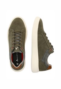 Gröna mockaskor med grå tygdetaljer, beige gummisålar och grå snören. Har en brun läderheel patch och röda detaljer.